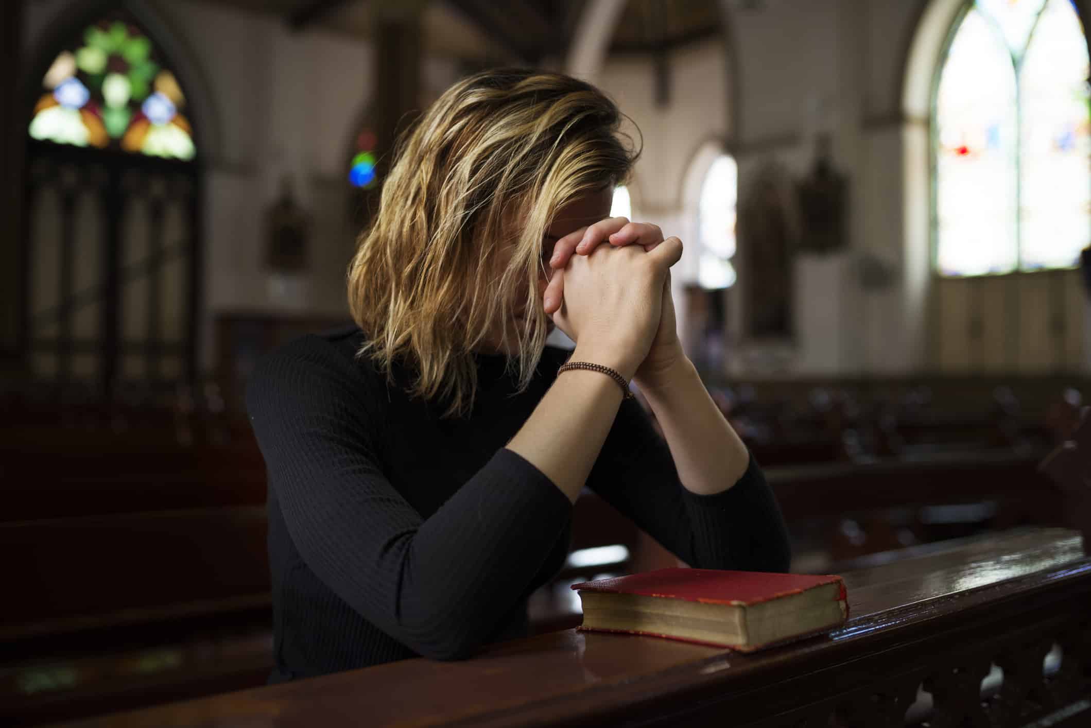Woman sitting in Church Praying